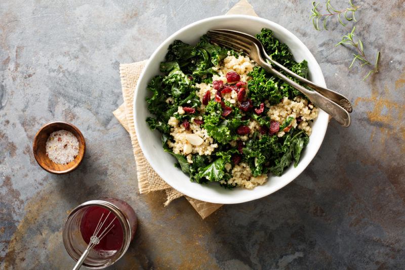 A bowl with cooked curly kale and other dinner ingredients