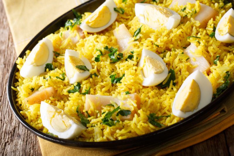 Kedgeree in a bowl. The meal includes rice, Indian spices, eggs and smoked fish