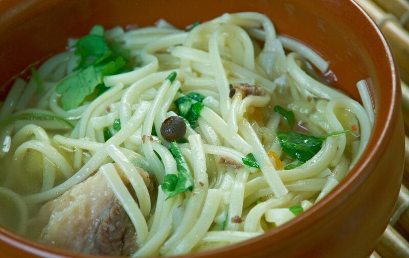 a closeup image of a brown bowl with kesme noodles