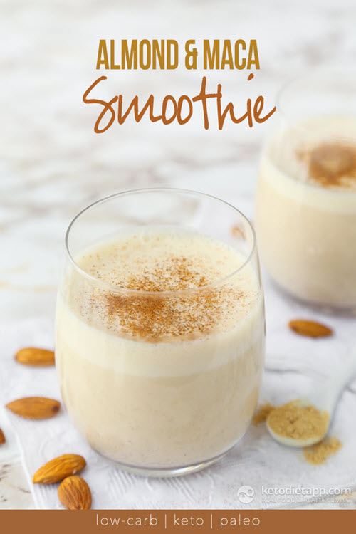 A light colored shake in a glass with almonds on a marble table