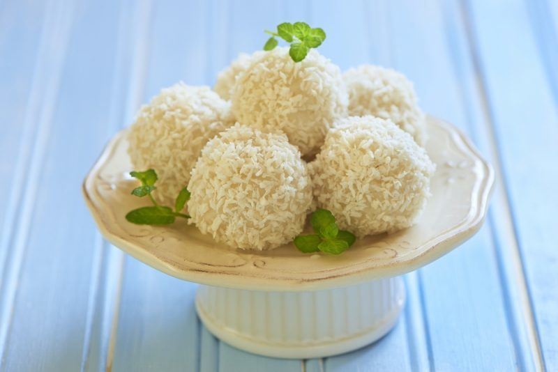 coconut fat bombs on a small serving plate with white table background