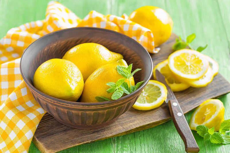 Keto Lemon Fat Bomb Recipes | Food For Net whole lemons in a brass bowl with cut lemons on a wooden board