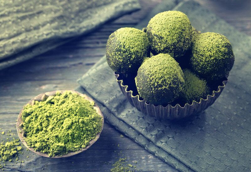 Keto Matcha Tea Fat Bomb Recipes | Food For Net Keto Matcha Tea Fat Bombs arranged in bowl with matcha tea powder on the side