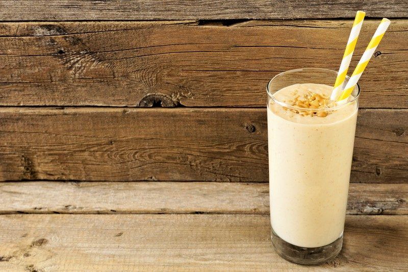 Keto Peanut Butter Smoothie Recipes | Food For Net Keto Peanut Butter Smoothie with reclaimed wood background and yellow straws