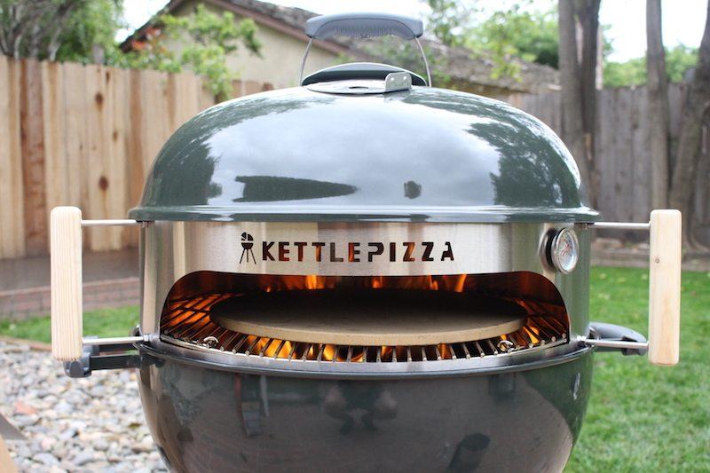 A front on view of a KettlePizza setup within a Weber grill