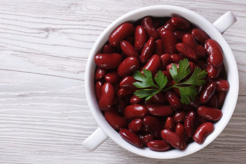 A white bowl with handles containing red kidney beans