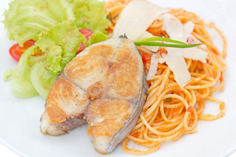 A steak of king mackerel cooked tomato pasta