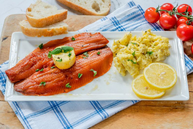 A meal containing kippers and eggs on a white plate