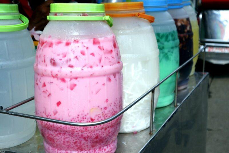 Large containers of a gulaman dessert, where you can see the chunks of agar-agar