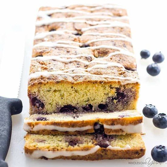 A zucchini loaf with blueberries and icing