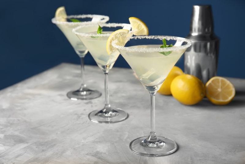 Three lemon drop cocktails served in martini glasses