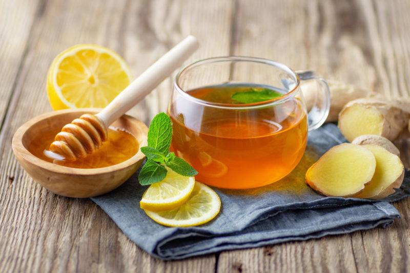 A mug containing lemon ginger and honey tea