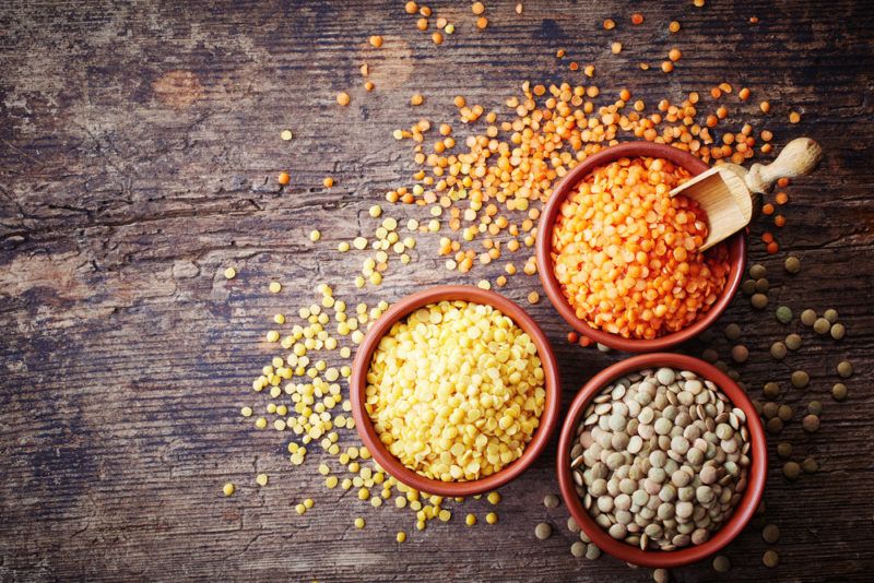 Three bowls with different colored lentils