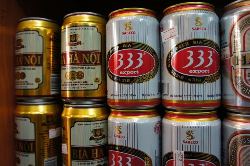 Cans of local Vietnamese beers stacked in a store