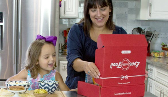 A mother and daughter opening a snack box