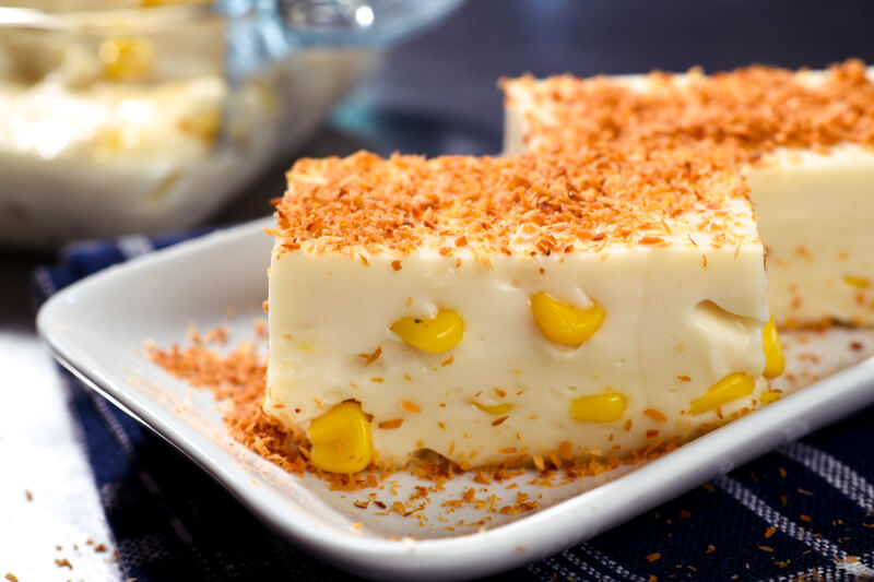 A white plate with two pieces of Maja Blanca