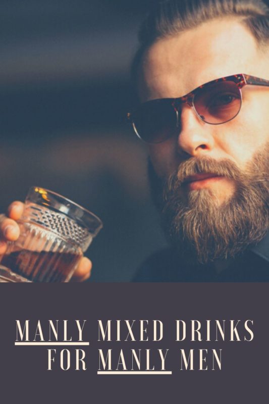 Manly Mixed Drinks. man in 30's with strong beard and brown liquor mixed drink