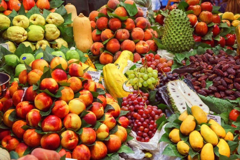 A large variety of fresh fruit being sold at a market in Spain