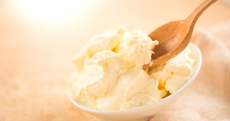 Mascarpone cheese in a white bowl with a spoon