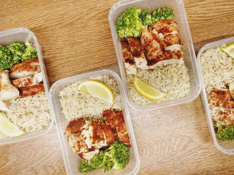 Four meal prep dinners with chicken, broccoli and rice