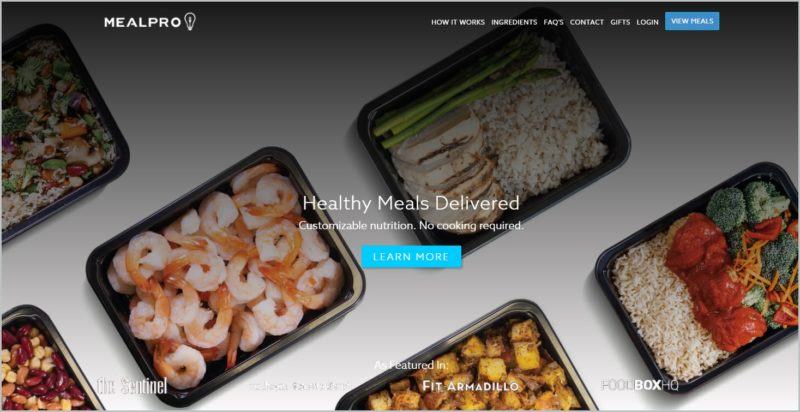 screenshot of MealPro homepage with top view image of prepared meals in black rectangular container and 'learn more' button at the middle