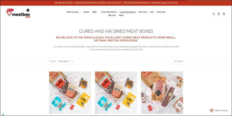 screenshot of Meatbox Cured and Air Dried Meat Boxes' web page, mainly white page with a red announcement bar on top followed by the website's name and main menu, the page displays the details and images of the different dried meat boxes.