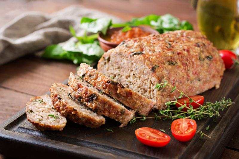 Sliced meatloaf on a black table