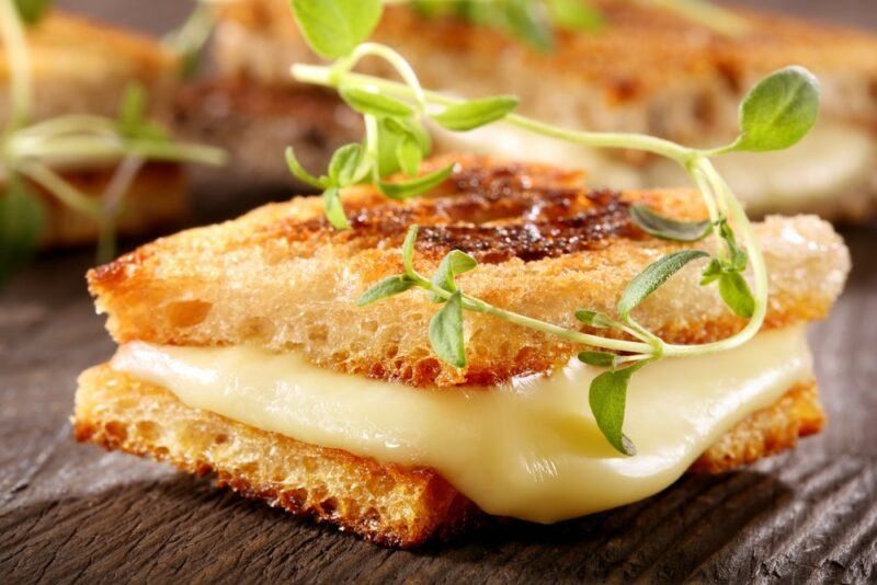 Melted cheese between two crackers with herbs