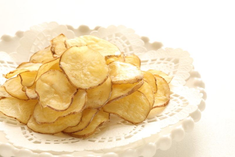 A plate of potato chips that have been cooked in the microwave