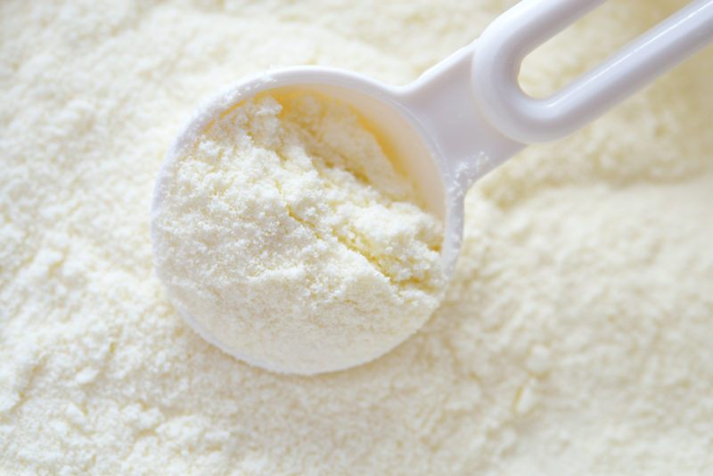 White milk powder with a white scoop