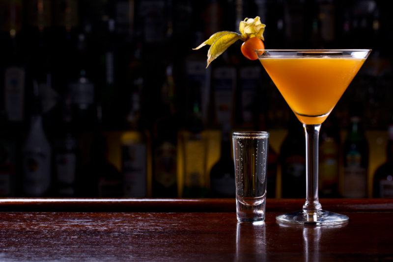 A orange millionaire cocktail in a martini glass