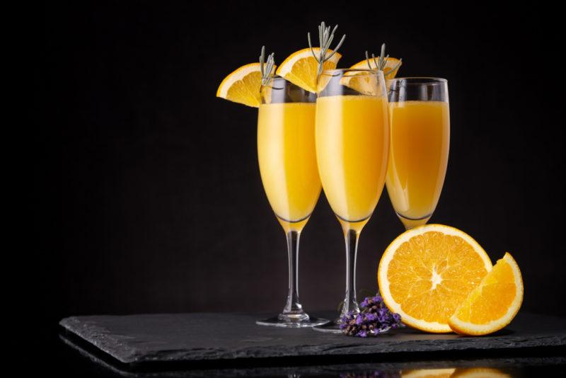 Three mimosas in cocktail glasses