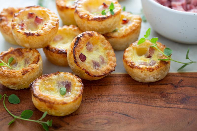 Small quiches on a wooden board