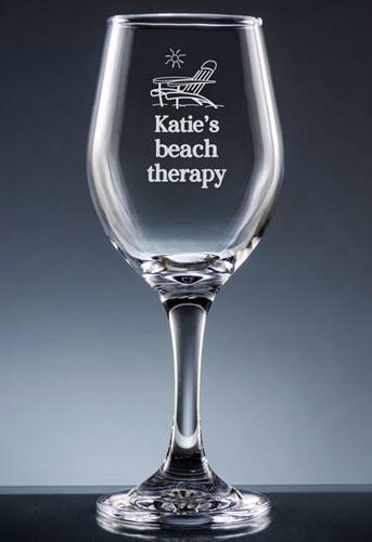 Miramar Wine Glass With Stem | Food For Net Clear wine glass with a deck chair and Katie's beach therapy engraved