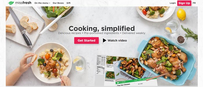 A marble counter with cooked meals and bread