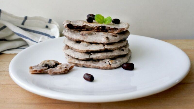 A white plate with a stack of cookies that have mochi as a filling