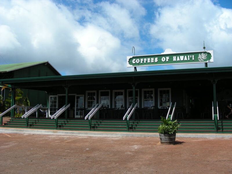 A Molokai Coffee store with clouds and a blue sky