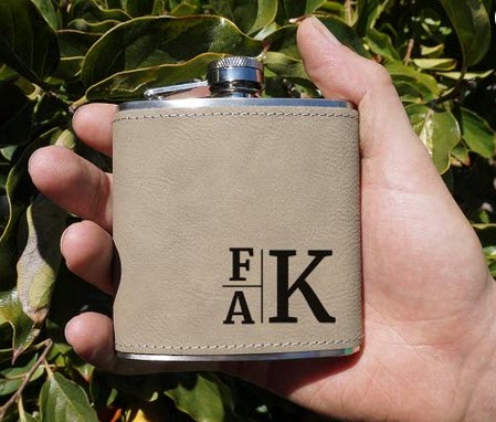 Monogram-Leather-Hip-Flask | Food For Net Light brown flask with 3 letters engraved into it
