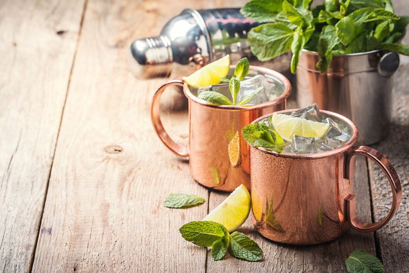 Two Moscow Mule cocktails in copper mugs