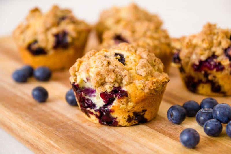 A few breakfast muffins with cream cheese and blue berries