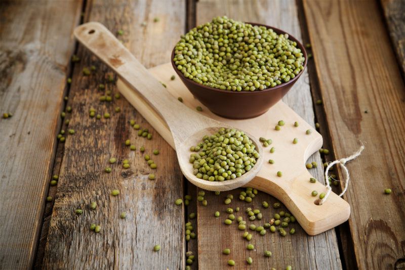 Mung beans in a wooden bowl and a spoon