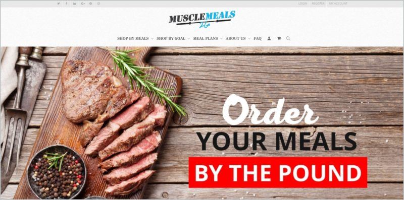 screenshot of Muscle Meals 2 Go homepage with a top view image of sliced meat on a wooden chopping board, with fresh rosemary sprigs and a small dish with spices