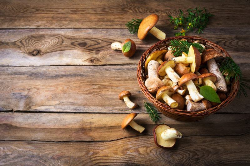 A bowl of mushrooms on a wooden table