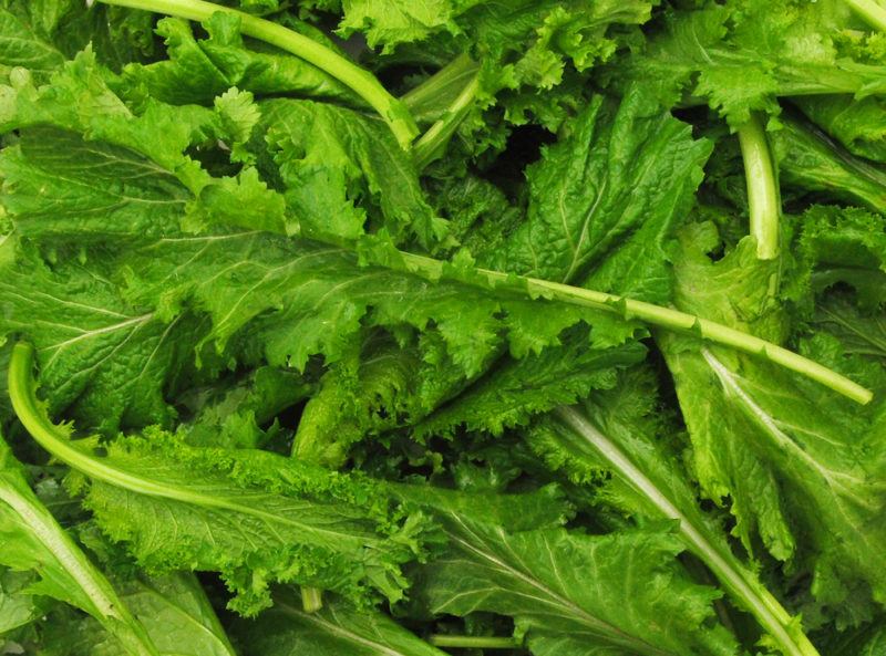 Leaves of mustard greens on a table