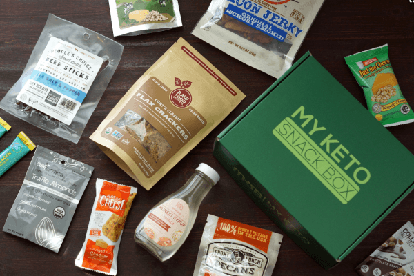 Selection of keto snacks and a green box on a table