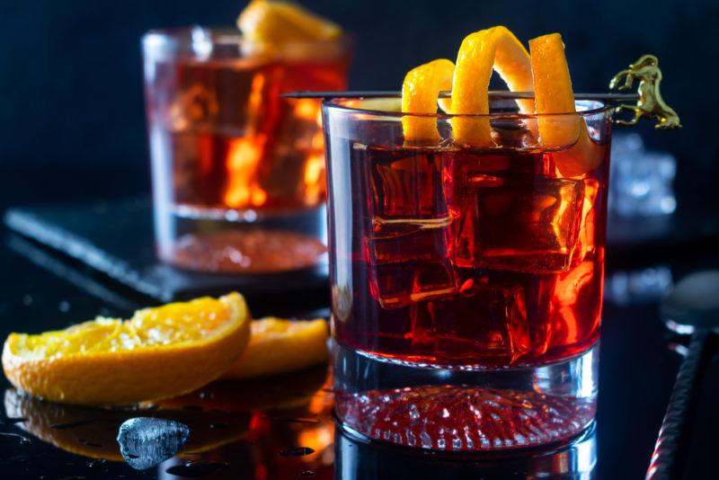 Two negroni cocktails in glasses with a lemon twist