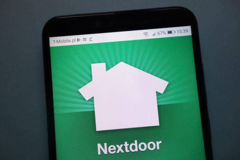 The Nextdoor app with a green background on a cellphone