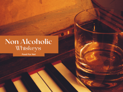 A glass of non alcoholic whiskey on a piano