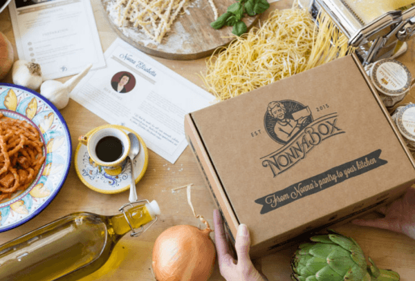 A table with Italian products and food, plus a brown box