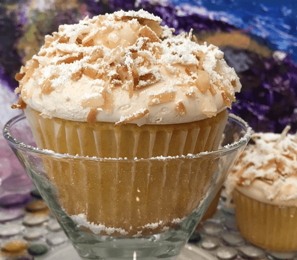 A large cupcakes with icing and a yummy topping